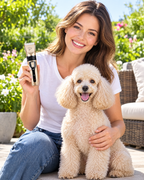 Groomed poodle on a sunny patio with its owner holding the Calivo pet hair trimmer