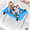Blue stand - Shih Tzu being rinsed on the blue grooming stand over a bathtub