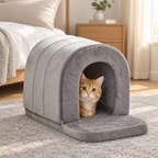 Ginger cat peeking out of the grey cave pet house